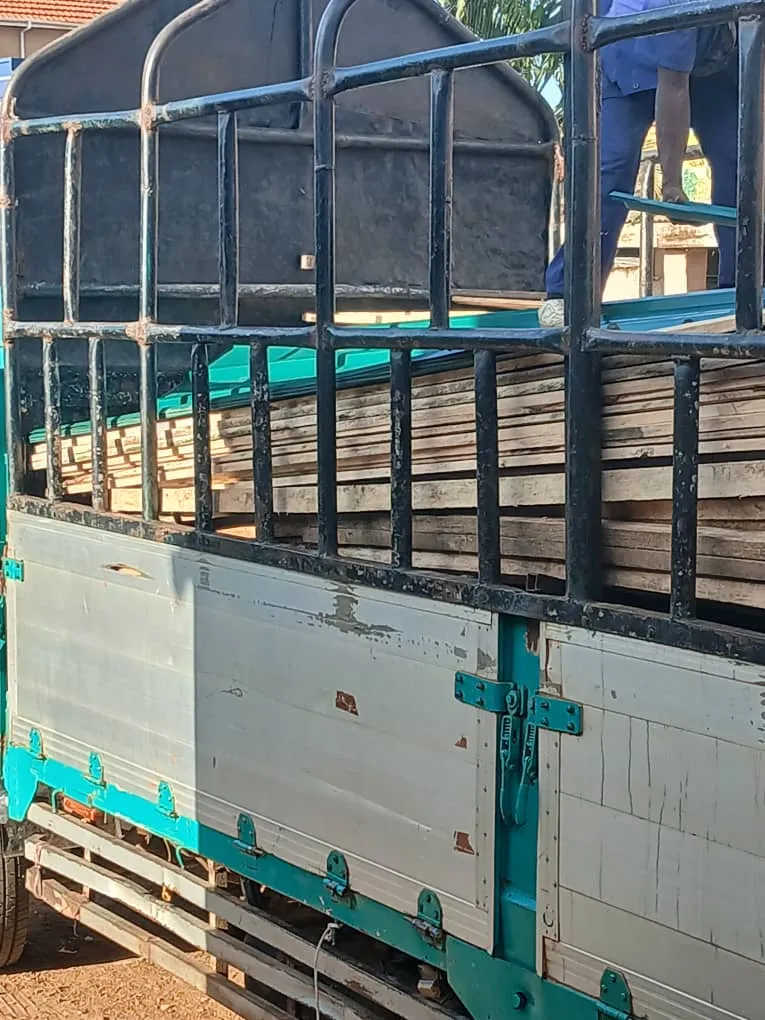 Truck delivering lumber and roofing materials to the school site